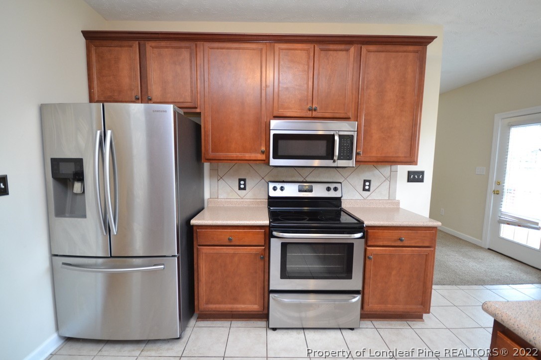 3608 Talus Road Fayetteville, NC 28306 - Photo 15 of 46 a kitchen with a refrigerator stove and microwave