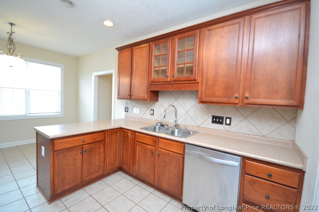 3608 Talus Road Fayetteville, NC 28306 - Photo 17 of 46 a kitchen with stainless steel appliances granite countertop a sink stove and cabinets