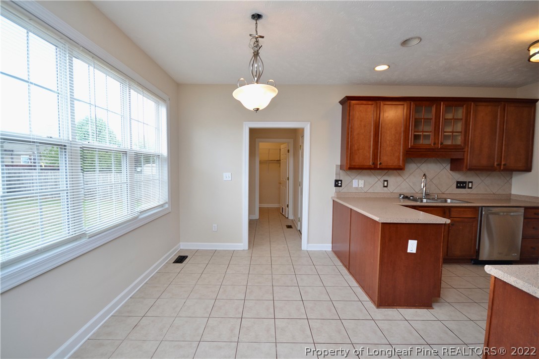 3608 Talus Road Fayetteville, NC 28306 - Photo 20 of 46 a large kitchen with stainless steel appliances granite countertop a stove a sink and a microwave