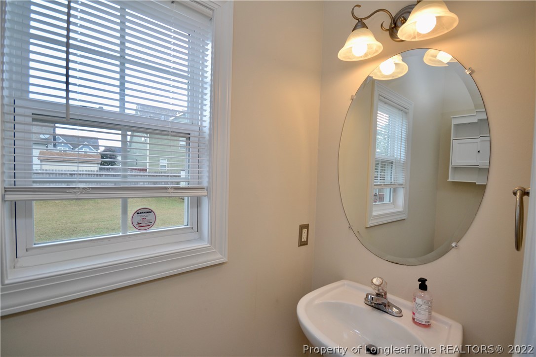 3608 Talus Road Fayetteville, NC 28306 - Photo 23 of 46 a bathroom with a sink a mirror and a window