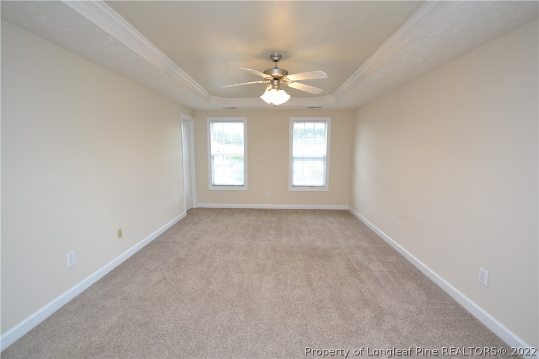 3608 Talus Road Fayetteville, NC 28306 - Photo 24 of 46 an empty room with windows and ceiling fan