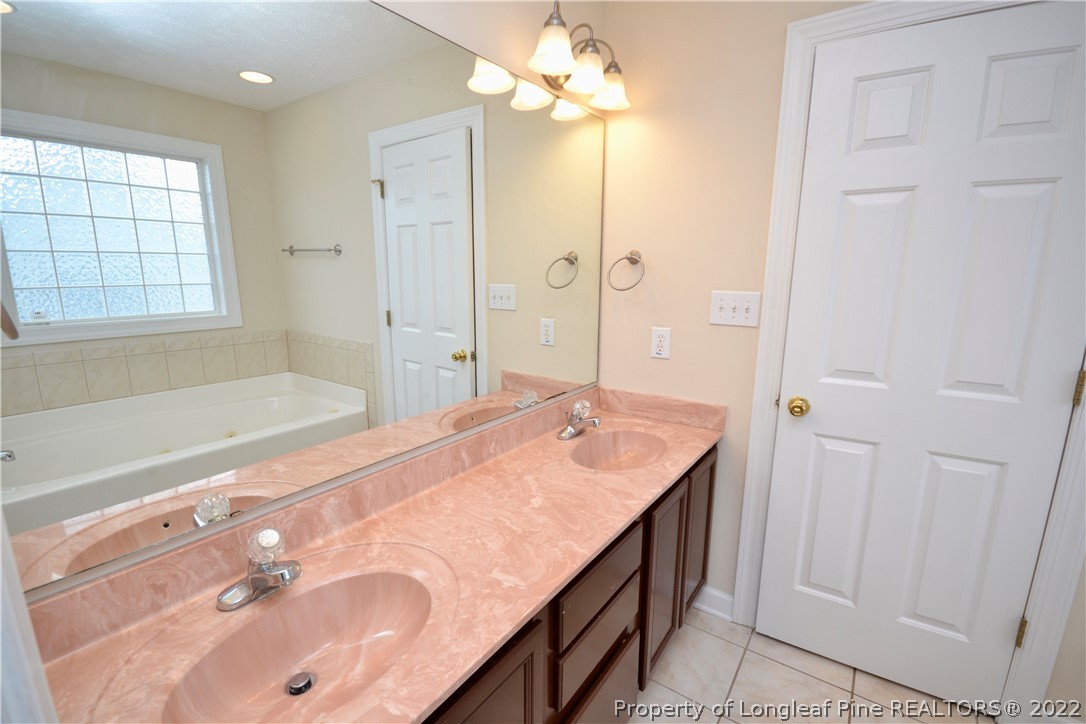 3608 Talus Road Fayetteville, NC 28306 - Photo 26 of 46 a spacious bathroom with a tub sink and mirror