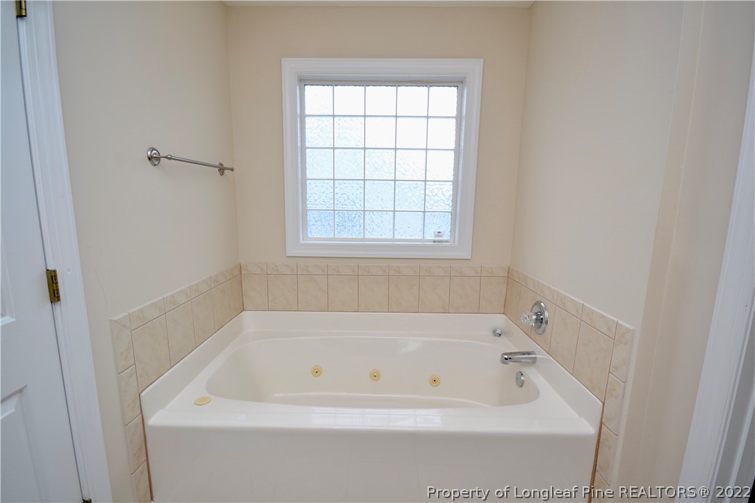 3608 Talus Road Fayetteville, NC 28306 - Photo 27 of 46 a white bath tub sitting in a bathroom