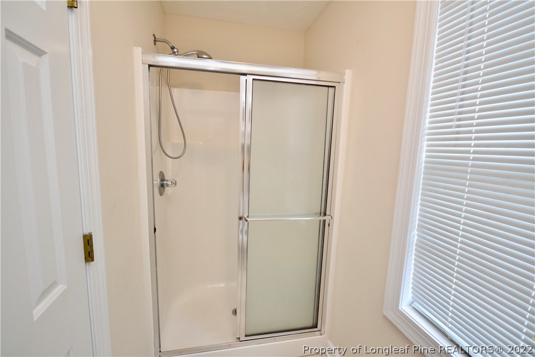 3608 Talus Road Fayetteville, NC 28306 - Photo 28 of 46 a bathroom with a glass shower door