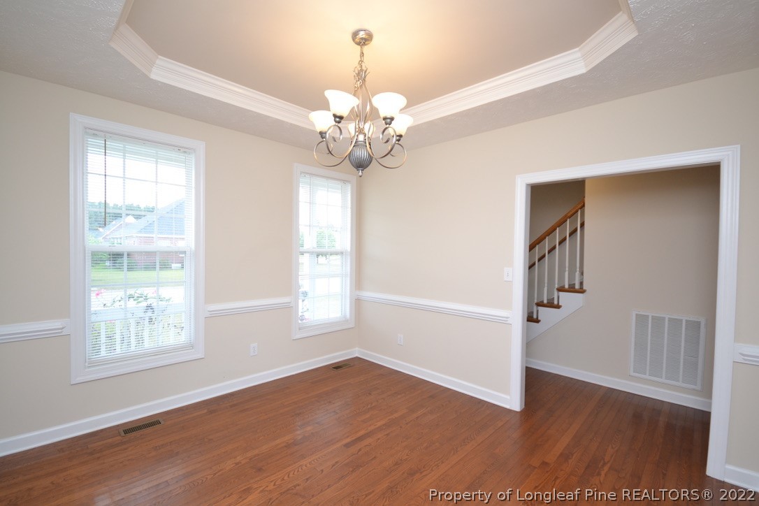 3608 Talus Road Fayetteville, NC 28306 - Photo 7 of 46 a view of an empty room with wooden floor and a window