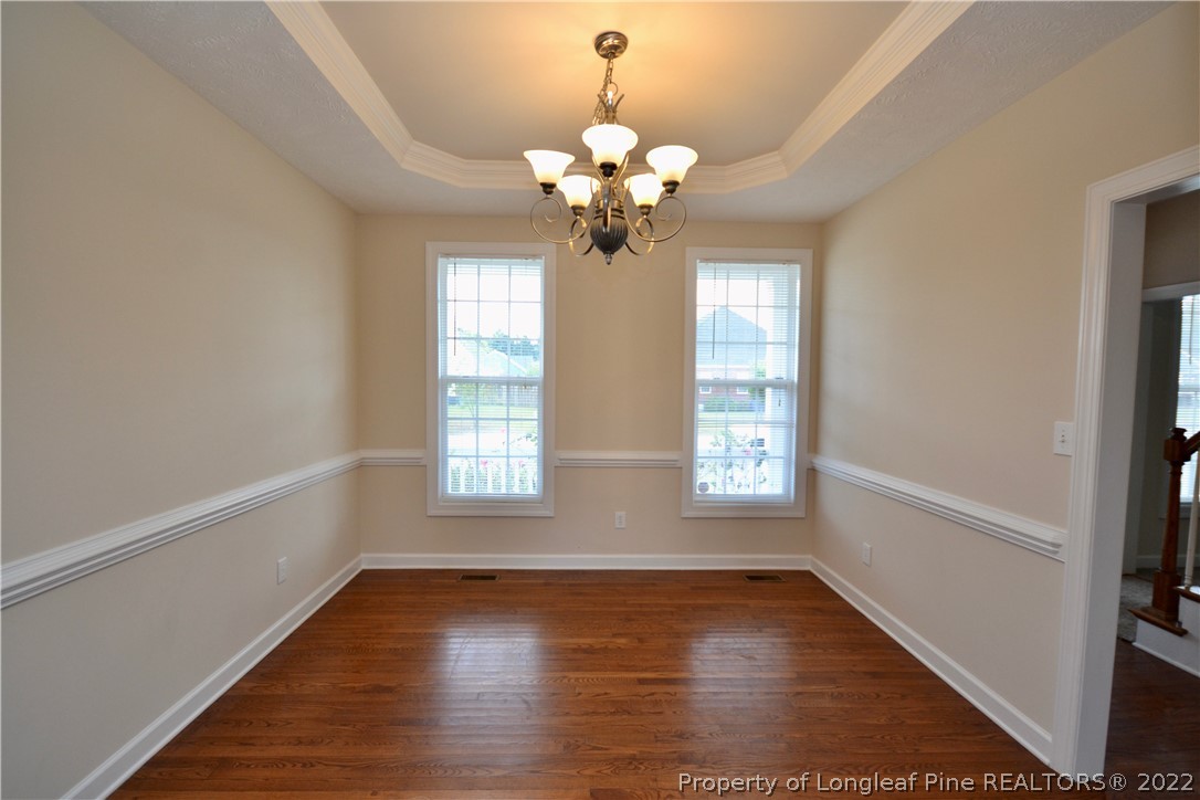 3608 Talus Road Fayetteville, NC 28306 - Photo 8 of 46 a view of an empty room with wooden floor and a window