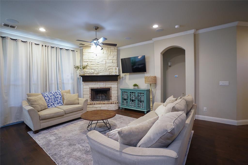 3009 Treasure View Drive Decatur, TX 76234 - Photo 11 of 26 Living room with ornamental molding, dark wood-style floors, a fireplace, a ceiling fan, and recessed lighting
