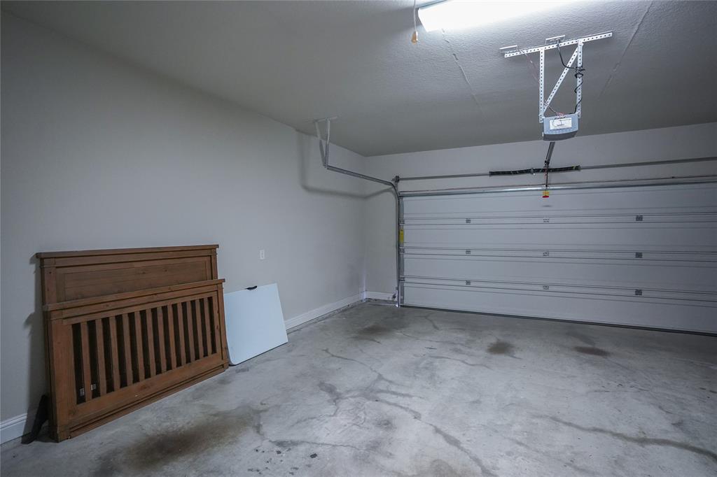 3009 Treasure View Drive Decatur, TX 76234 - Photo 23 of 26 Garage with a garage door opener and baseboards