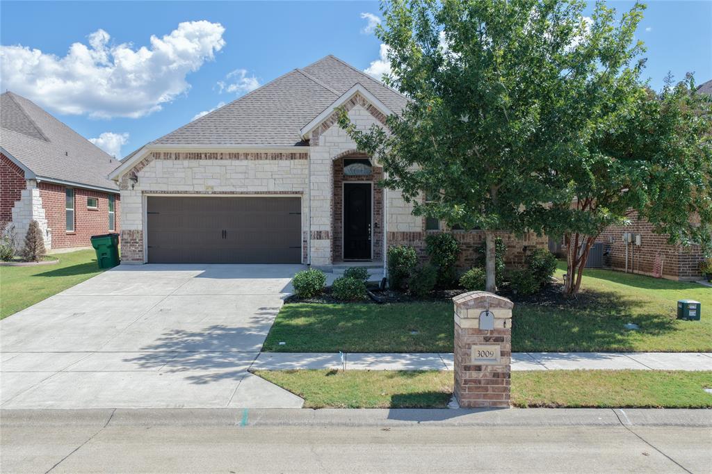 3009 Treasure View Drive Decatur, TX 76234 - Photo 5 of 26 Front view featuring stone siding, concrete driveway, a garage, and brick siding