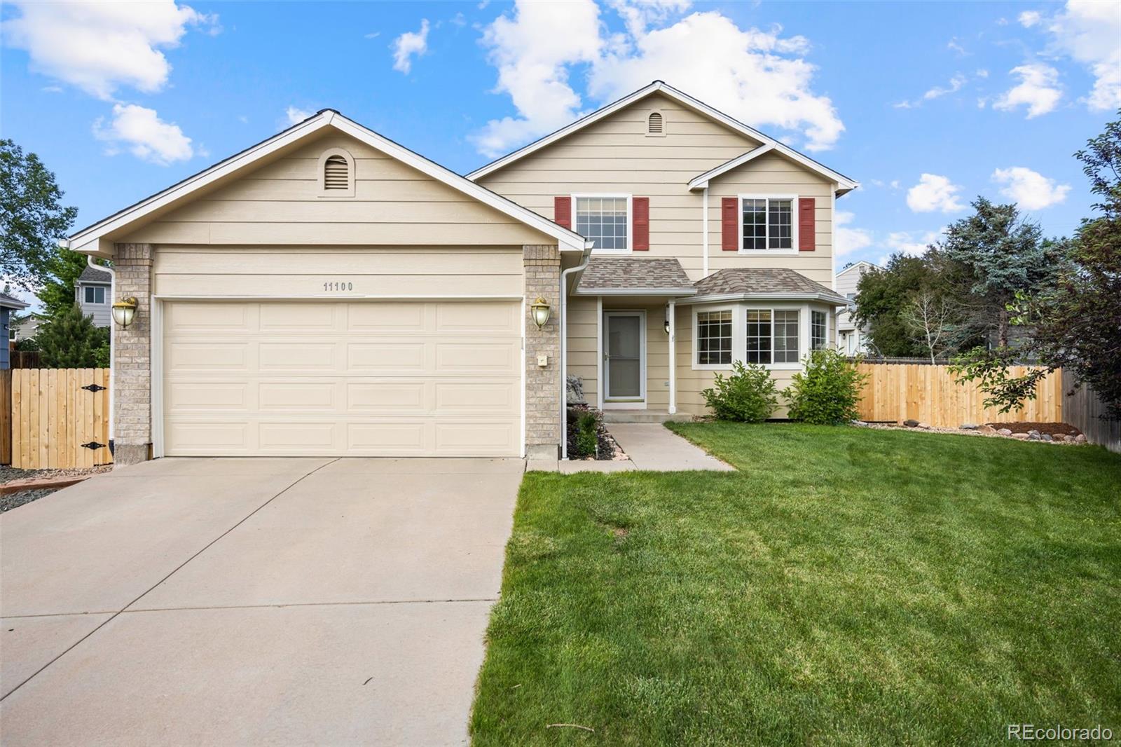 a view of house with yard and green space