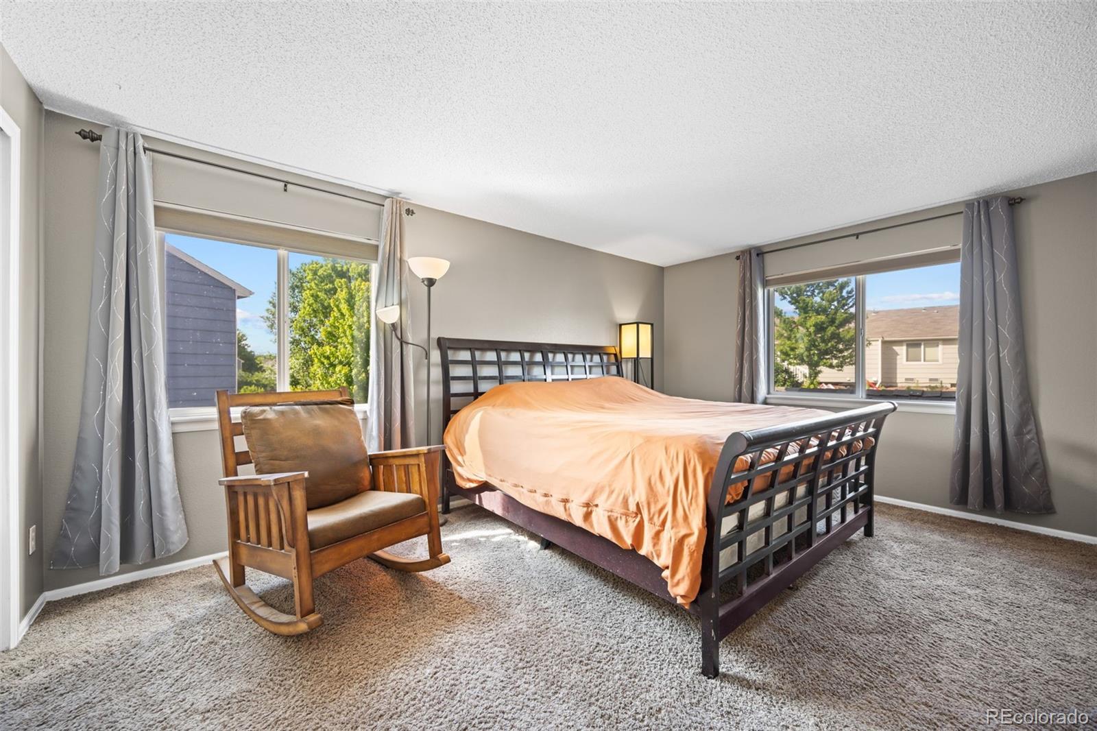 11100 Callaway Court Parker, CO 80138 - Photo 13 of 39 a bed sitting in a bedroom next to a window