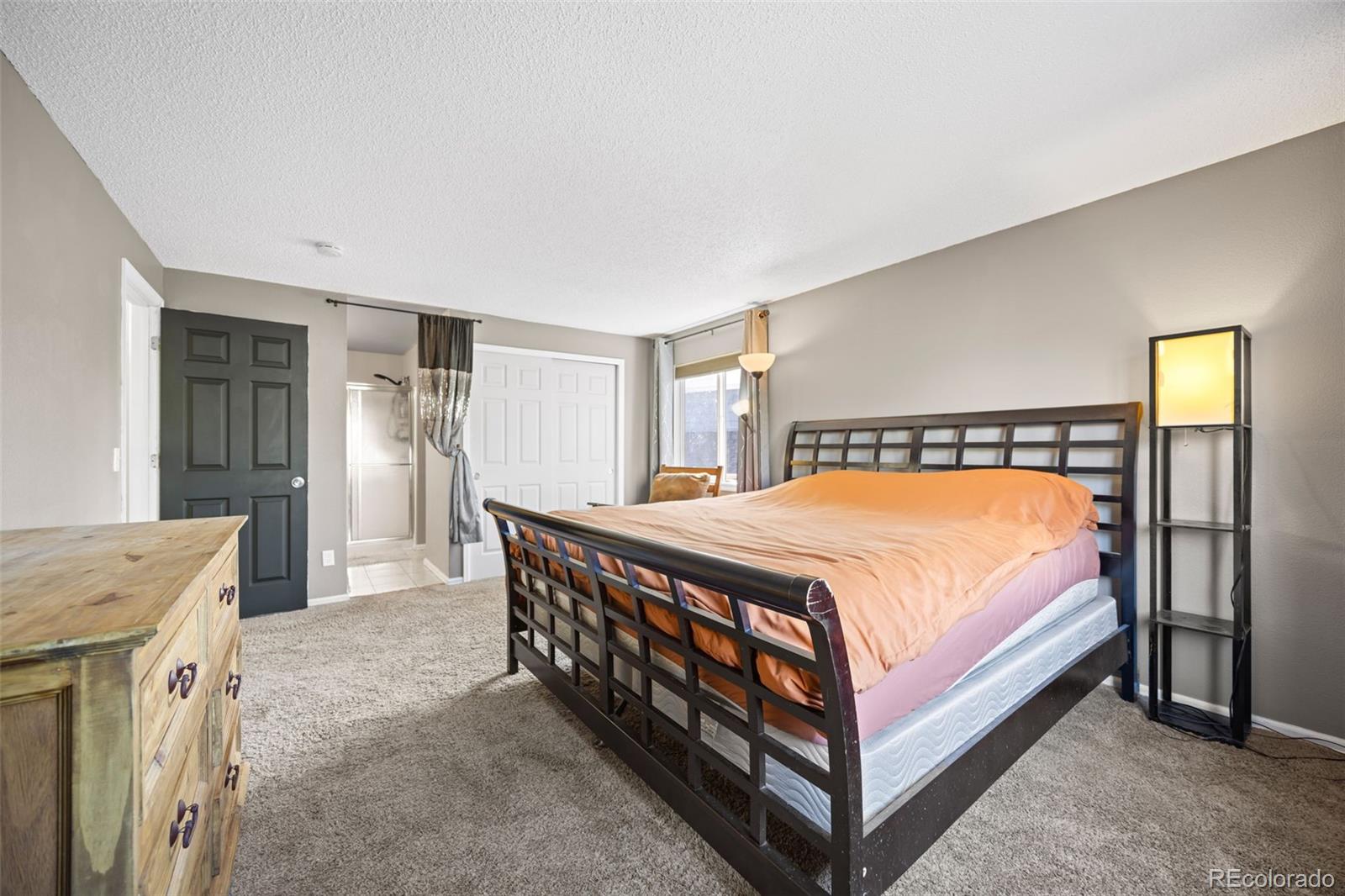 11100 Callaway Court Parker, CO 80138 - Photo 14 of 39 a bed sitting in a spacious bedroom next to a window