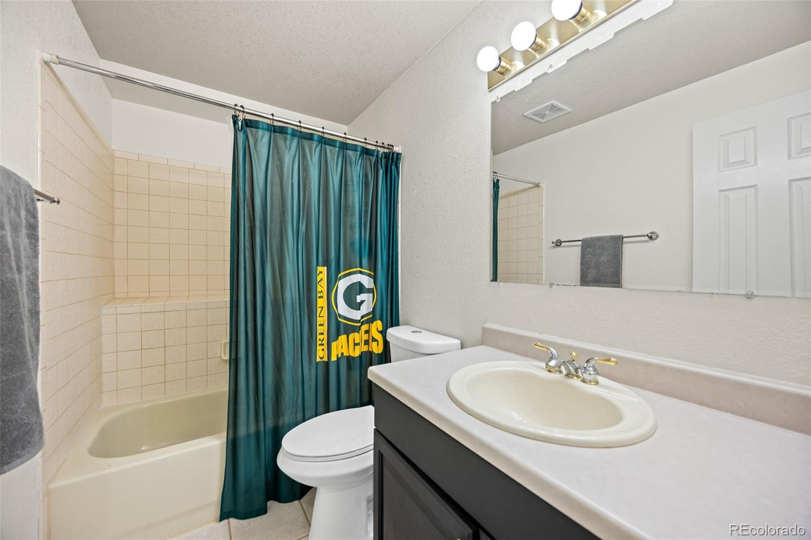11100 Callaway Court Parker, CO 80138 - Photo 22 of 39 a bathroom with a sink toilet and shower