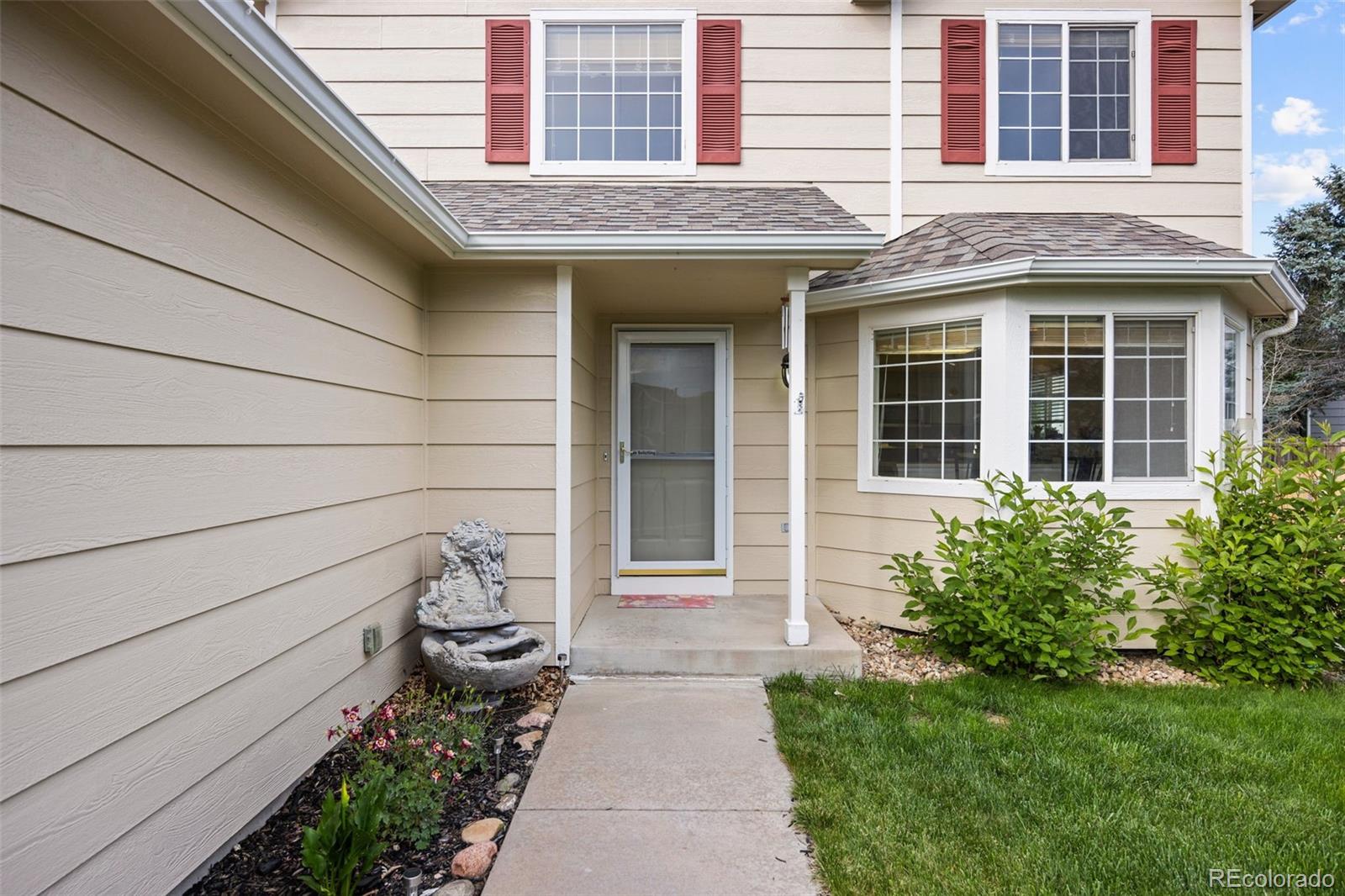 11100 Callaway Court Parker, CO 80138 - Photo 4 of 39 a front view of a house with a garden