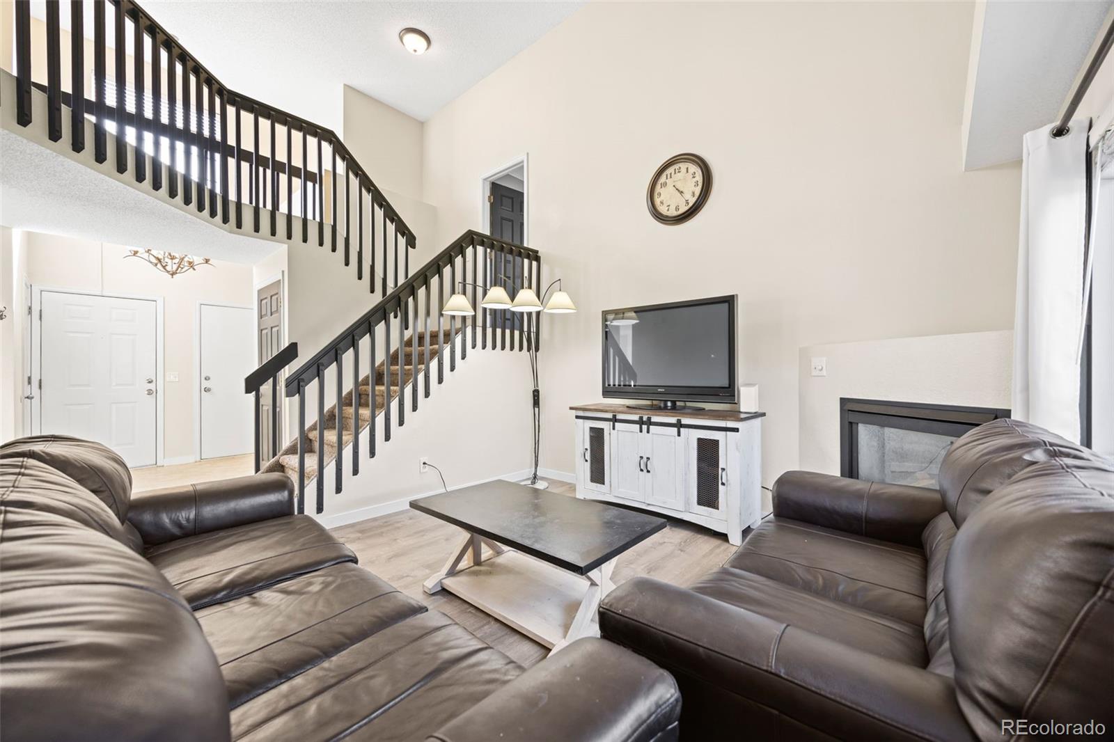 11100 Callaway Court Parker, CO 80138 - Photo 5 of 39 a living room with furniture and a flat screen tv