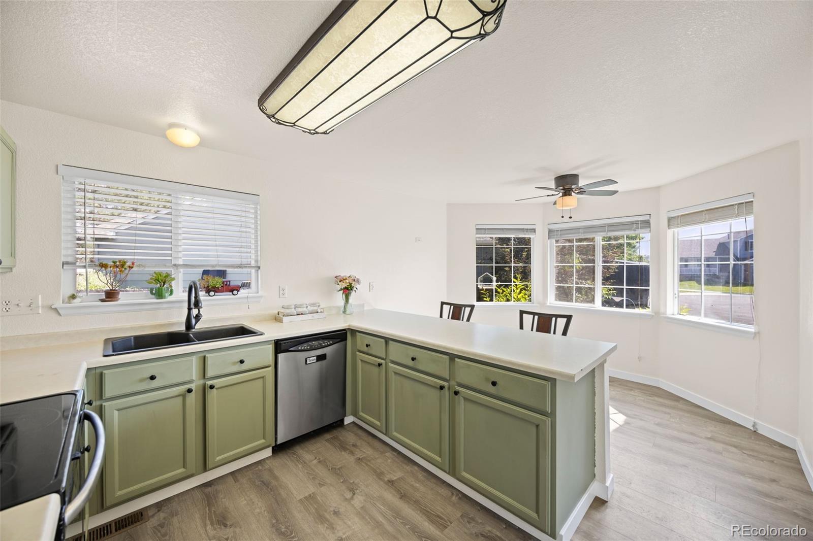 11100 Callaway Court Parker, CO 80138 - Photo 8 of 39 a kitchen with a sink cabinets and window