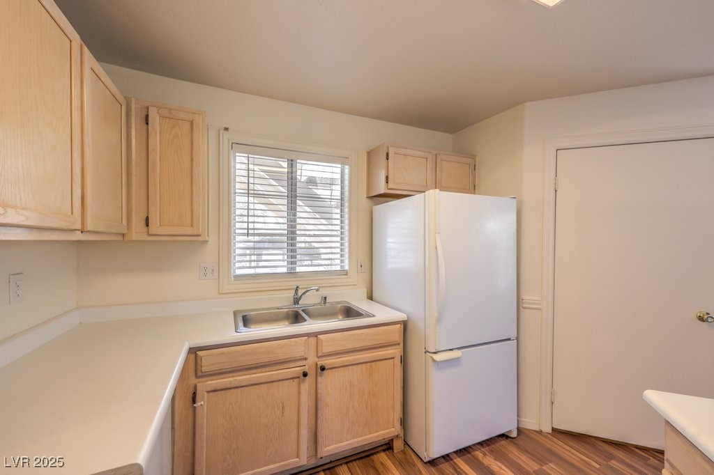 698 South Racetrack Road, Unit 1014 Henderson, NV 89015 - Photo 16 of 25 Kitchen featuring freestanding refrigerator, light brown cabinetry, a sink, light wood-style flooring, and light countertops