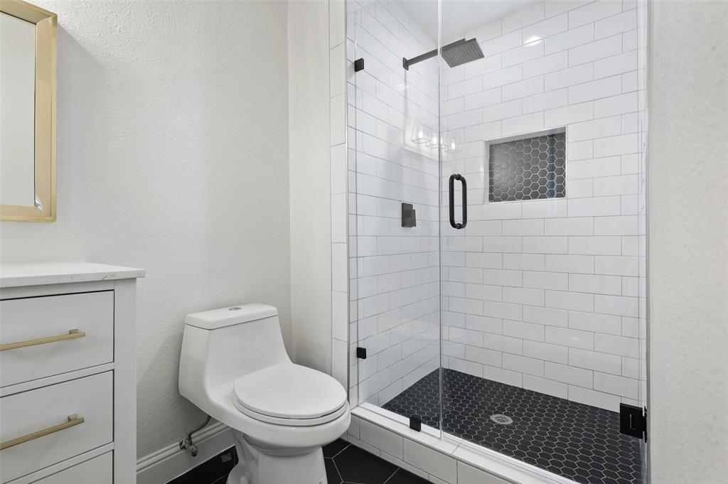 3126 Jubilee Trail Dallas, TX 75229 - Photo 20 of 38 a bathroom with a toilet and a shower