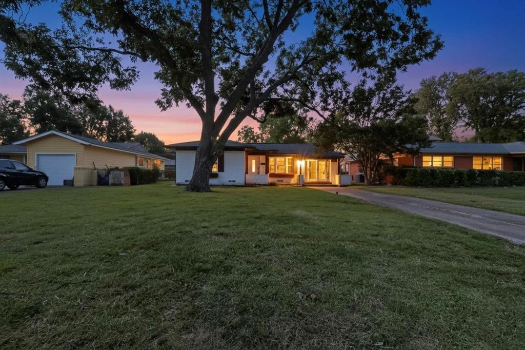 Single story home with a front lawn and a garage