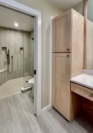 a bathroom with a shower and a sink
