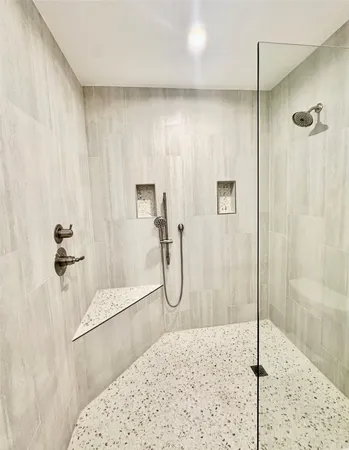 a bathroom with a granite countertop shower