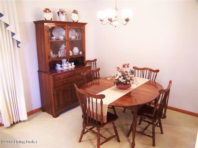 10907 Deering Road Louisville, KY 40272 - Photo 27 of 38 Dining Room with carpeting with hardwood underneath, wide open to the Living Room, new chandelier and doorway to Eat In Kitchen.