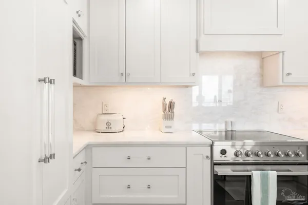 a kitchen that has a sink and a stove