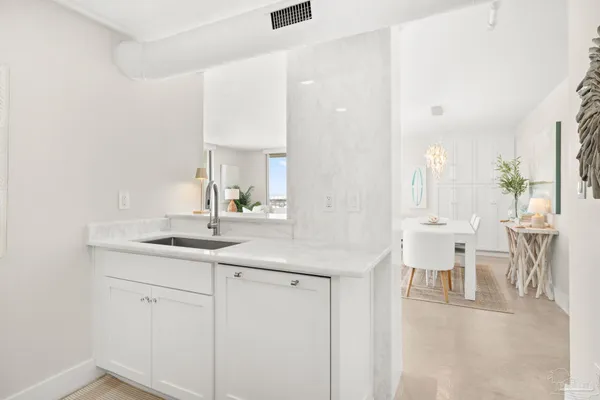 a kitchen with white cabinets and white appliances