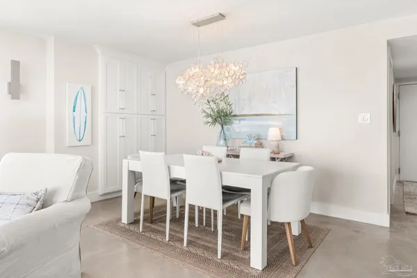 a dining room with furniture and a chandelier