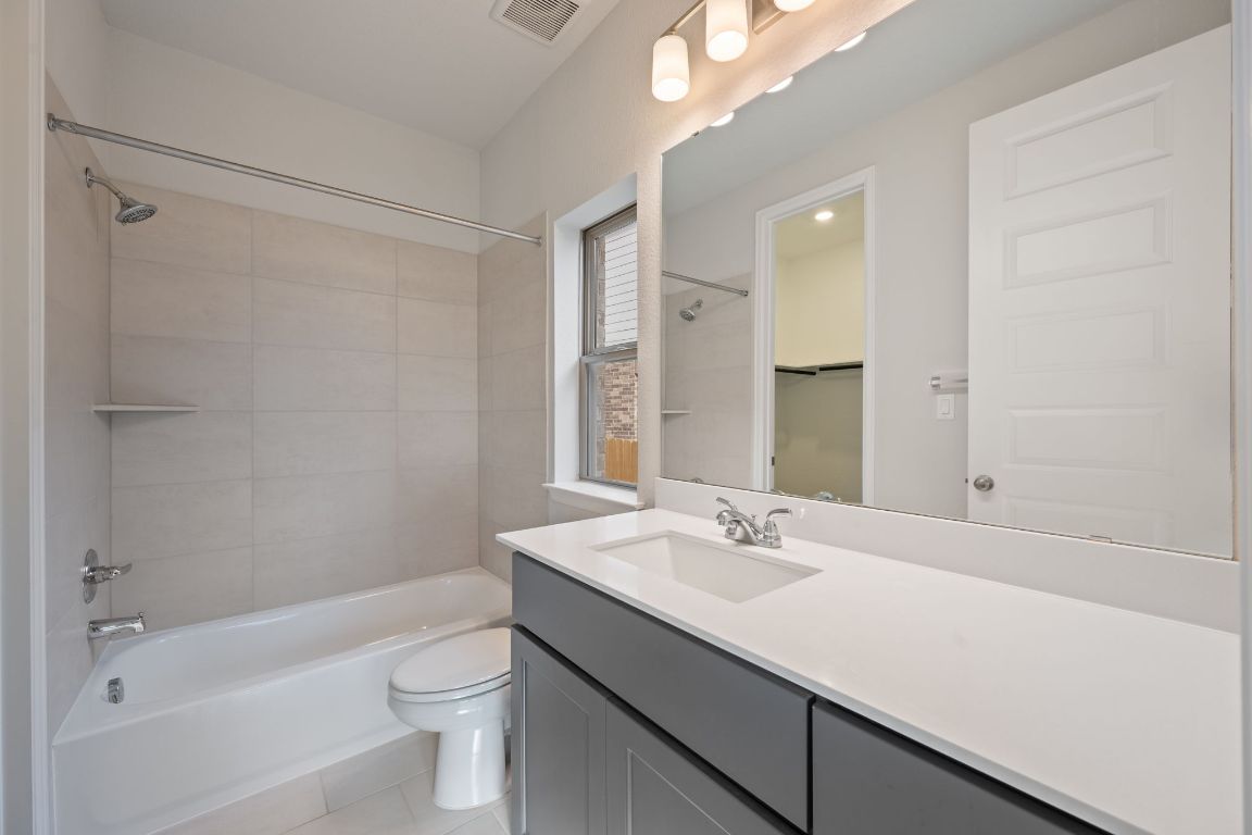 1037 Thunderhead Trail Georgetown, TX 78628 - Photo 20 of 33 a bathroom with a sink a toilet a shower and a mirror