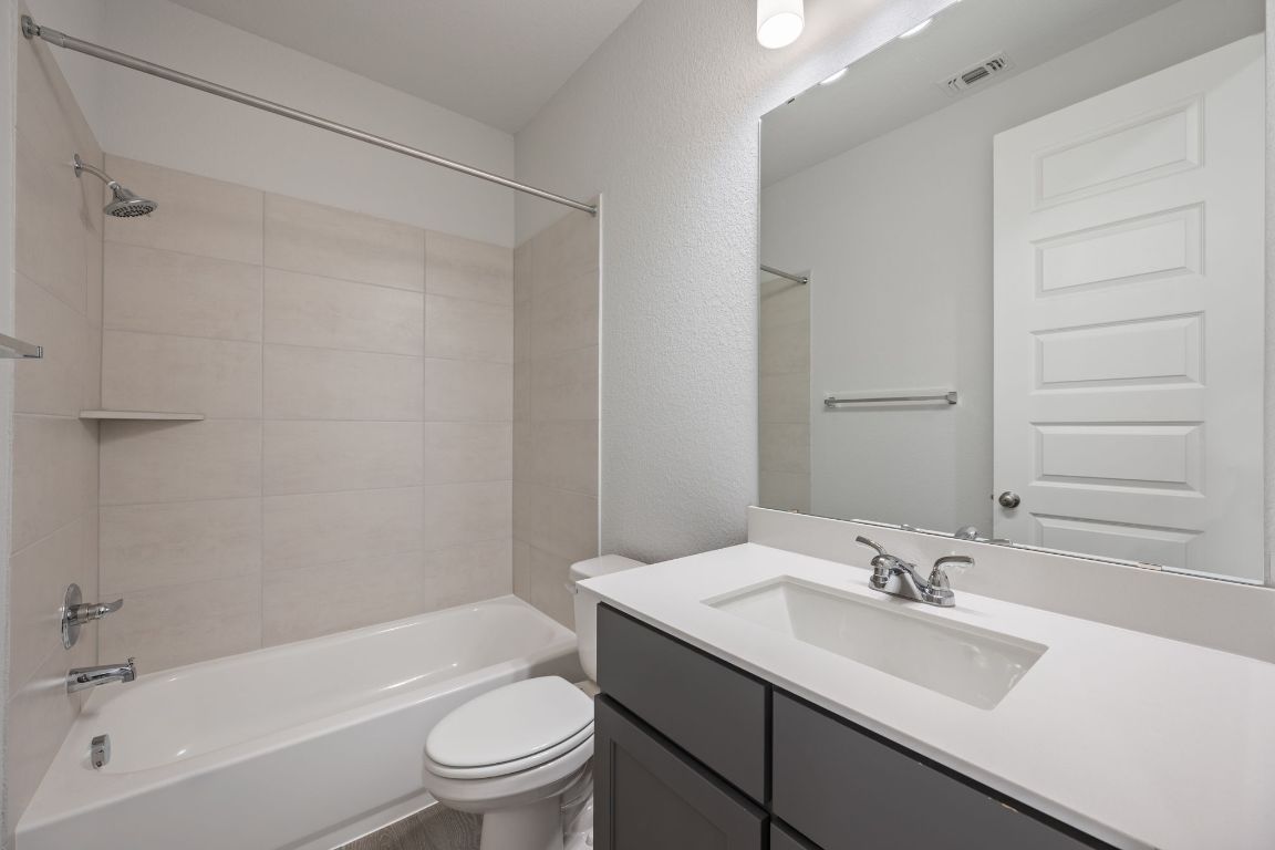 1037 Thunderhead Trail Georgetown, TX 78628 - Photo 23 of 33 a bathroom with a sink toilet tub and shower