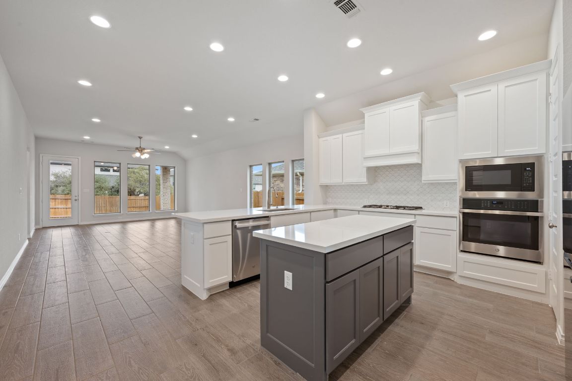 1037 Thunderhead Trail Georgetown, TX 78628 - Photo 5 of 33 a kitchen with a sink stove and cabinets