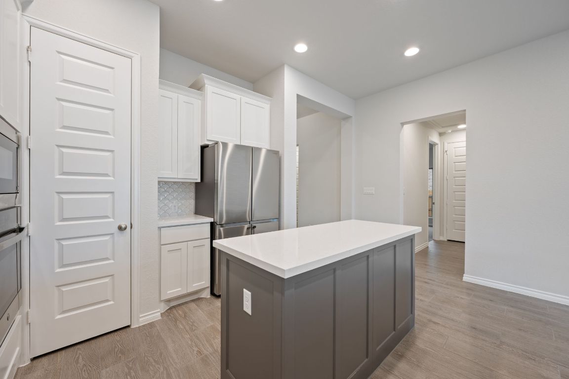 1037 Thunderhead Trail Georgetown, TX 78628 - Photo 8 of 33 a kitchen with a refrigerator and counter space