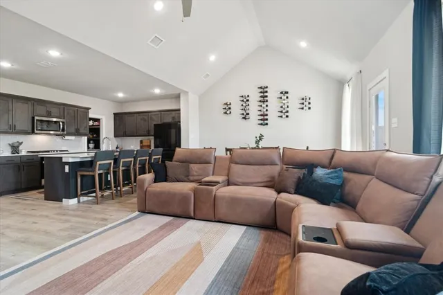 a living room with furniture kitchen view and a kitchen