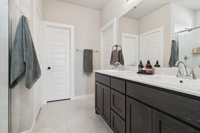 a bathroom with a sink vanity and mirror