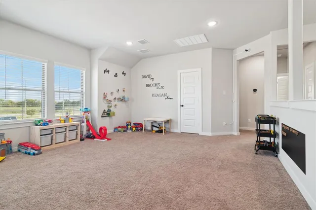 a view of a livingroom with workspace and a window