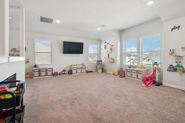 a view of a livingroom with furniture and a flat screen tv