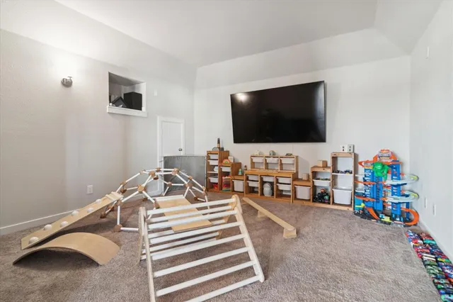 a bedroom with furniture and a flat screen tv