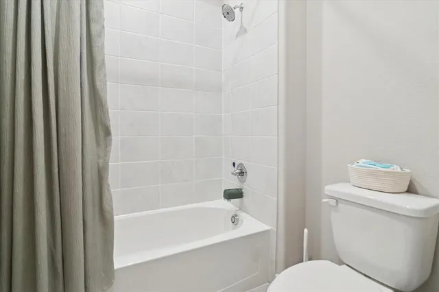 a bathroom with a toilet and a bathtub