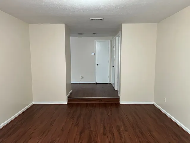 a view of room with wooden floor and window