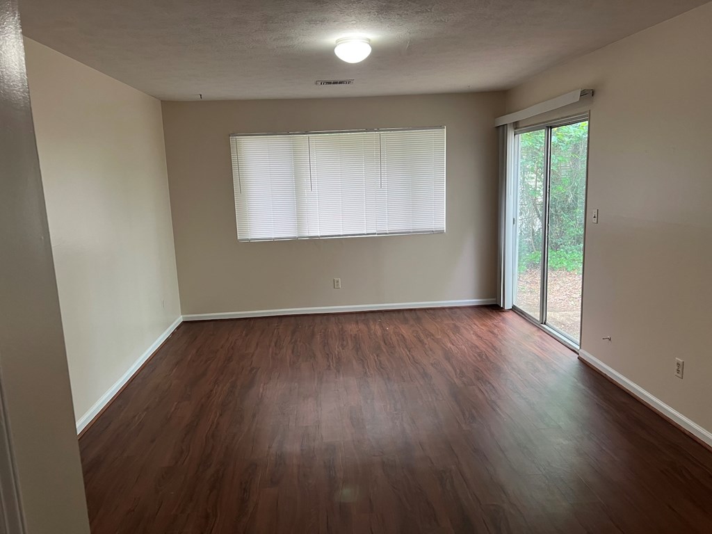 6323 Old Post Court Columbus, GA 31909 - Photo 3 of 13 an empty room with wooden floor and windows