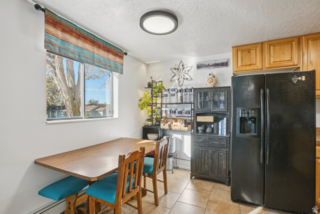 645 Swenson Avenue, Unit 3 Springville, UT 84663 - Photo 3 of 9 Dining area featuring a textured ceiling and light tile patterned flooring