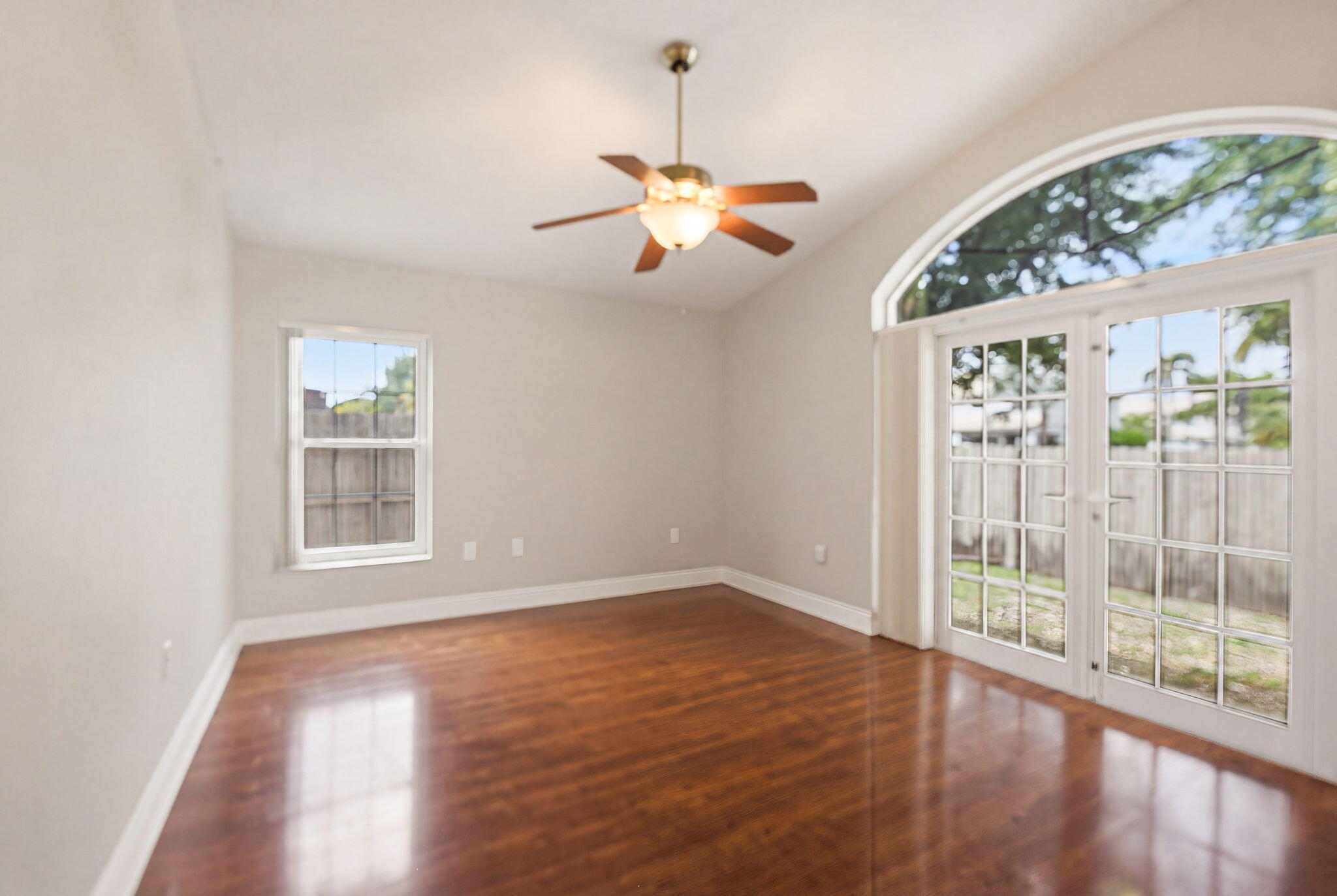 7350 Southwest 161st Place Miami, FL 33193 - Photo 12 of 31 a view of an empty room with wooden floor and a window