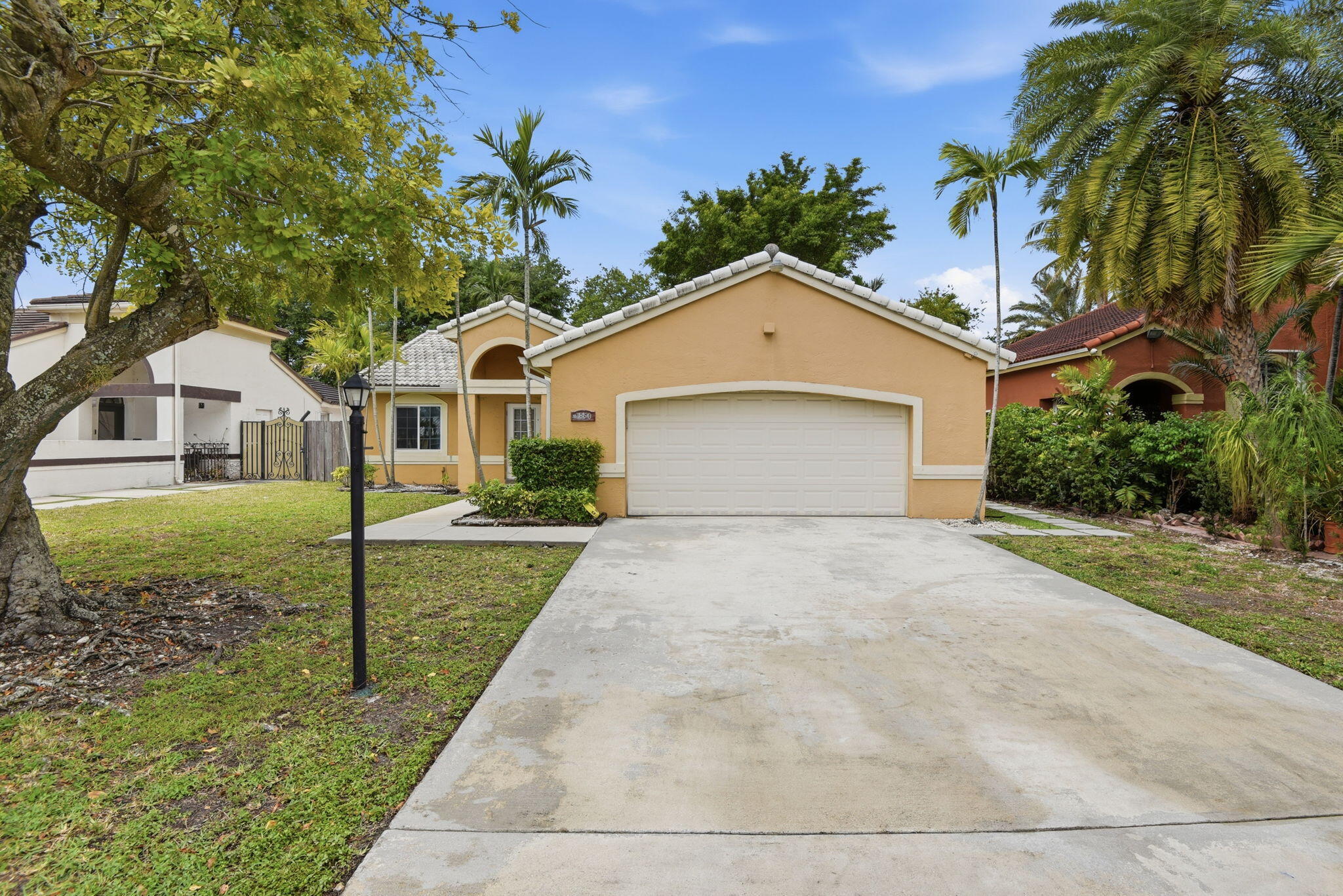 7350 Southwest 161st Place Miami, FL 33193 - Photo 2 of 31 a front view of a house with a yard and garage