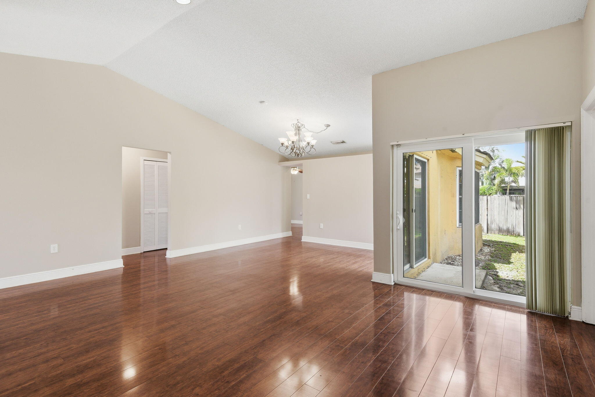 7350 Southwest 161st Place Miami, FL 33193 - Photo 5 of 31 an empty room with wooden floor and windows