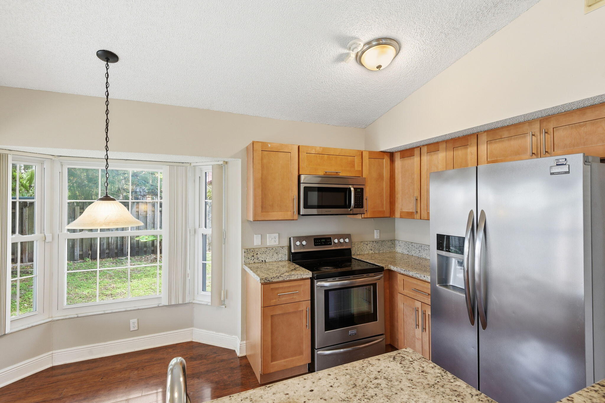 7350 Southwest 161st Place Miami, FL 33193 - Photo 10 of 31 a kitchen with a refrigerator and a sink