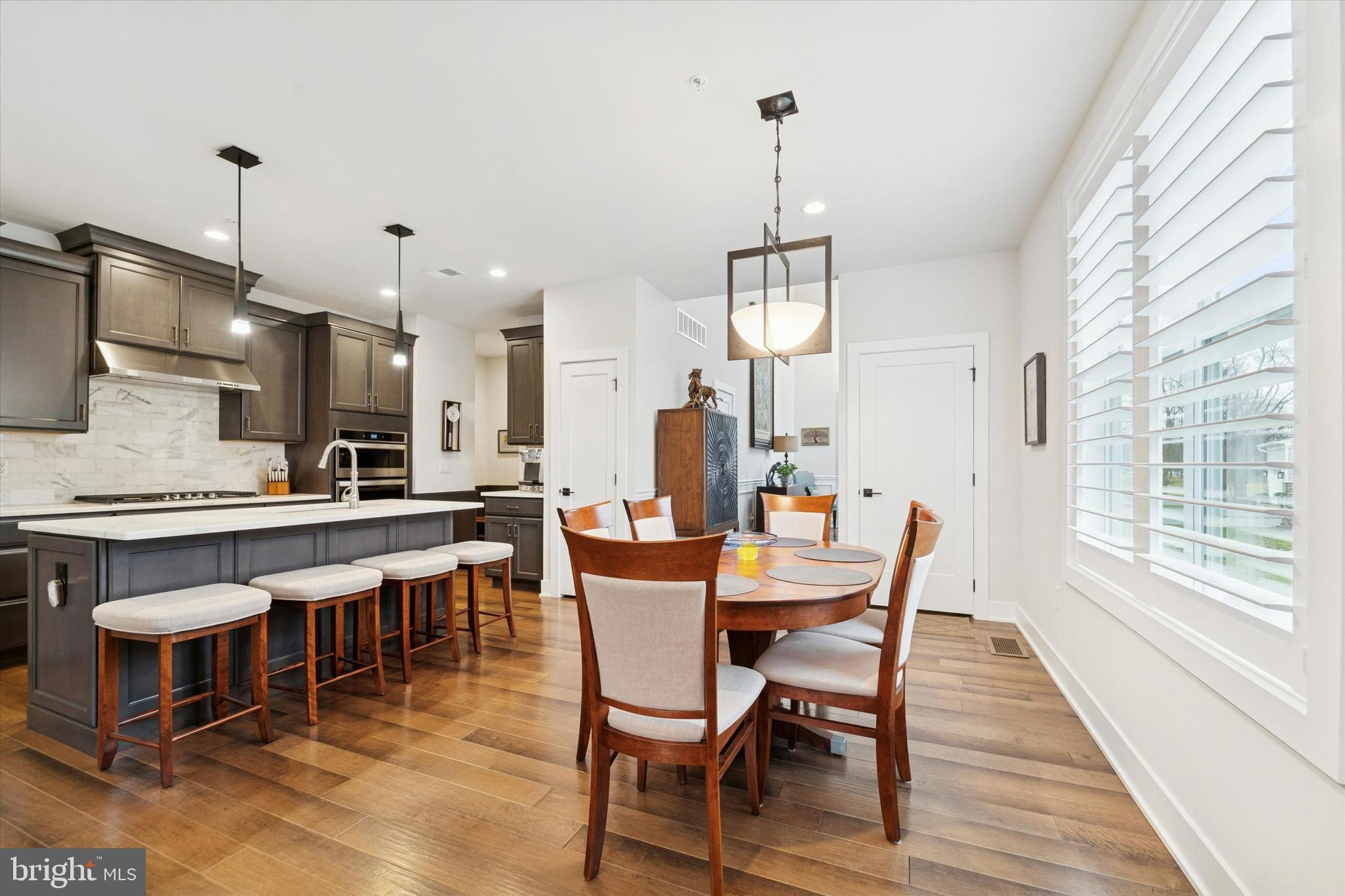 658 Levering Street Blue Bell, PA 19422 - Photo 12 of 38 a view of a dining room and livingroom with furniture wooden floor a chandelier