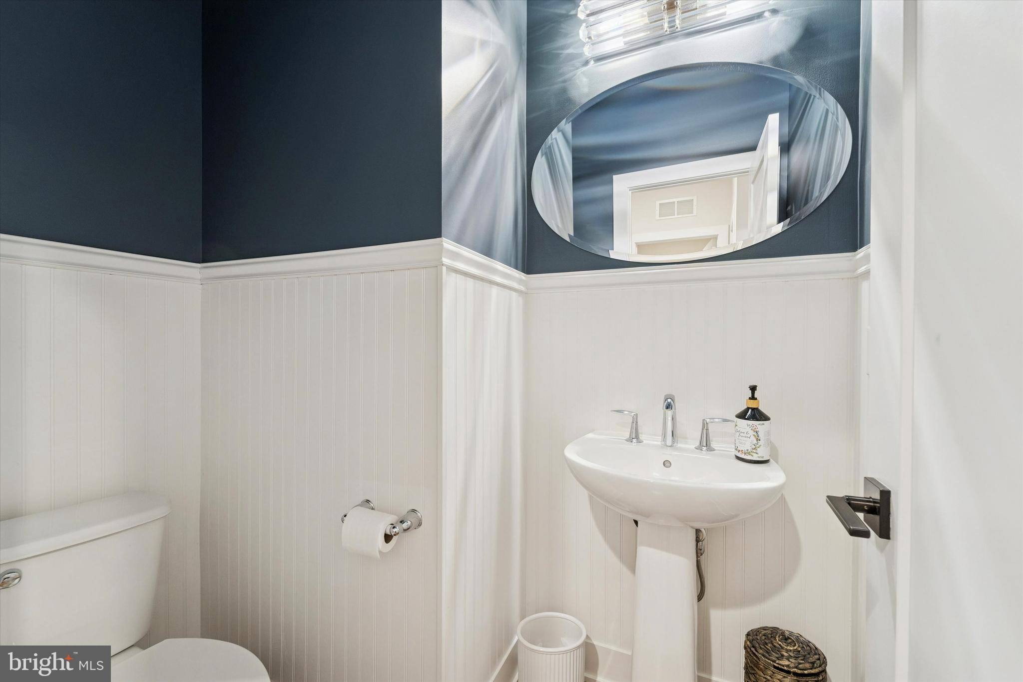 658 Levering Street Blue Bell, PA 19422 - Photo 14 of 38 a bathroom with a sink and mirror with toilet