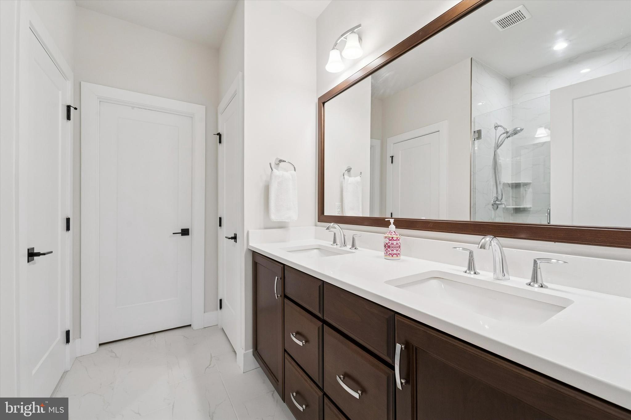 658 Levering Street Blue Bell, PA 19422 - Photo 18 of 38 a bathroom with double sink and a mirror