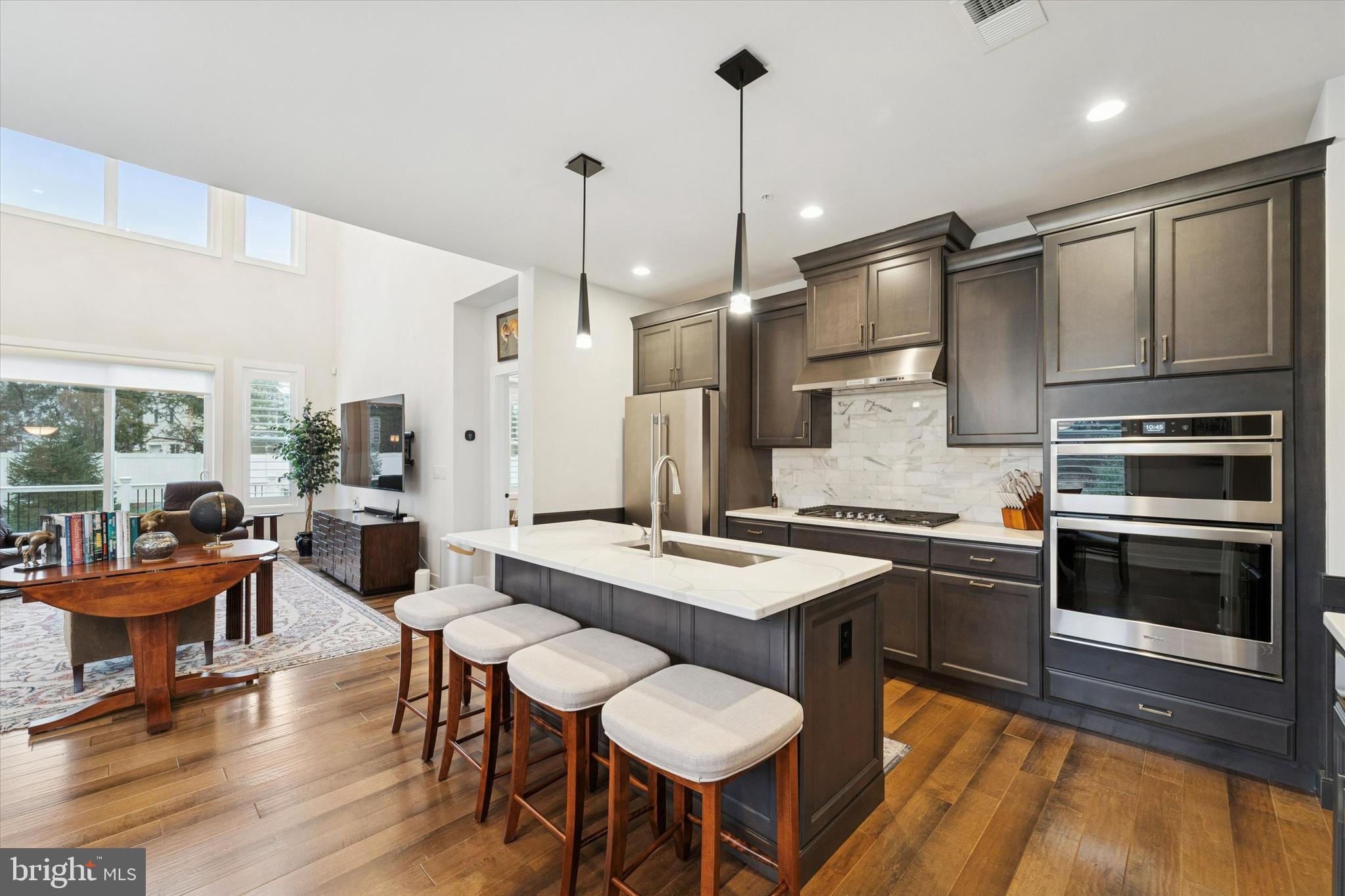 658 Levering Street Blue Bell, PA 19422 - Photo 7 of 38 a kitchen with stainless steel appliances granite countertop a stove a sink a microwave a dining table and chairs